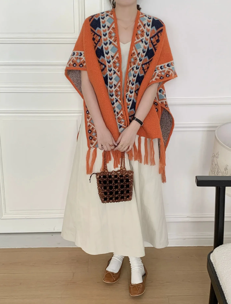 Women's geometric patterned cardigan with short sleeves and fringed edges