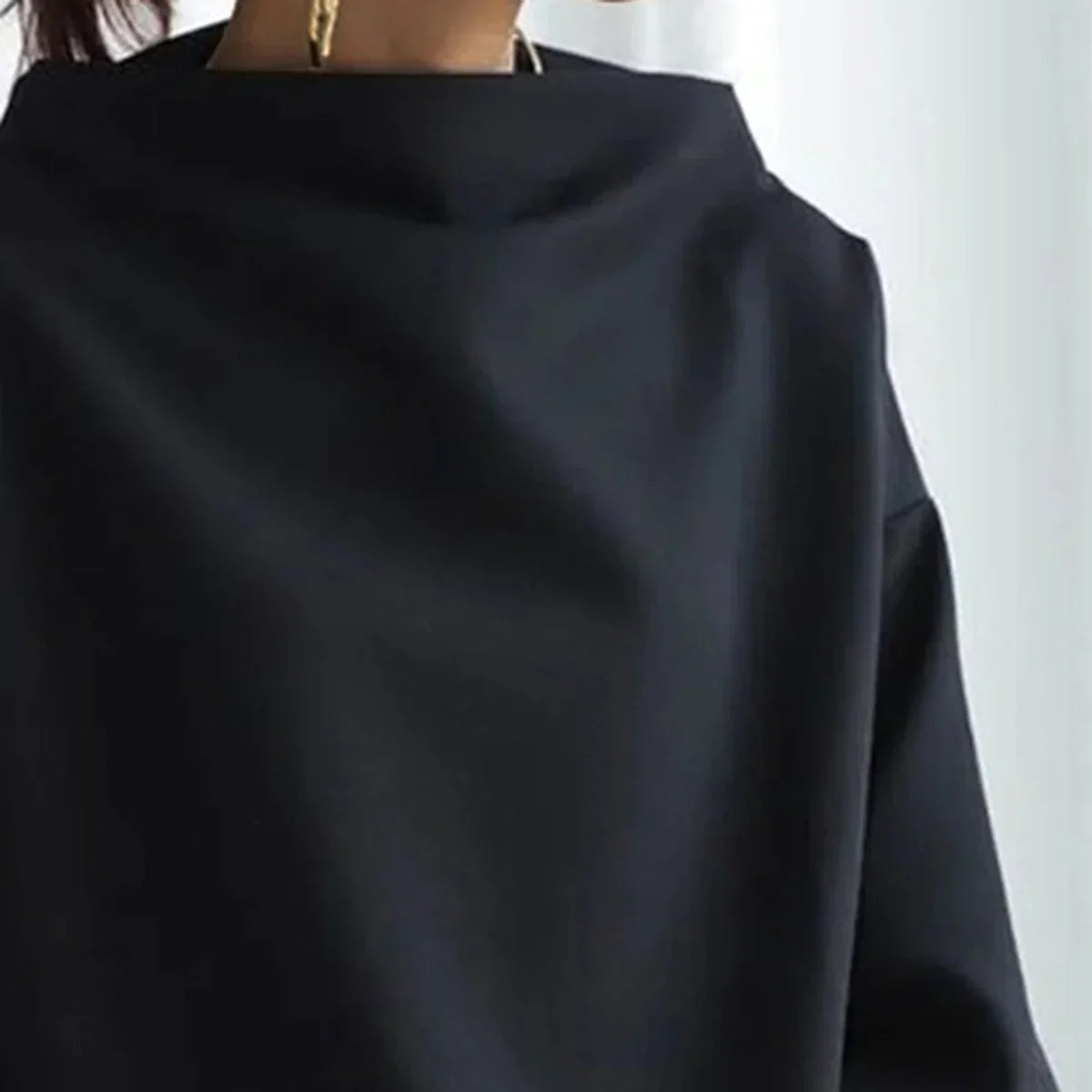 Women's black oversized jumper with mock neckline and long sleeves