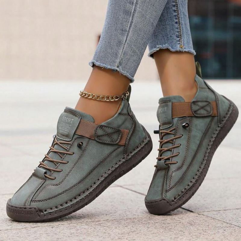Women's lace-up high-top trainers with ankle strap and stitched panels