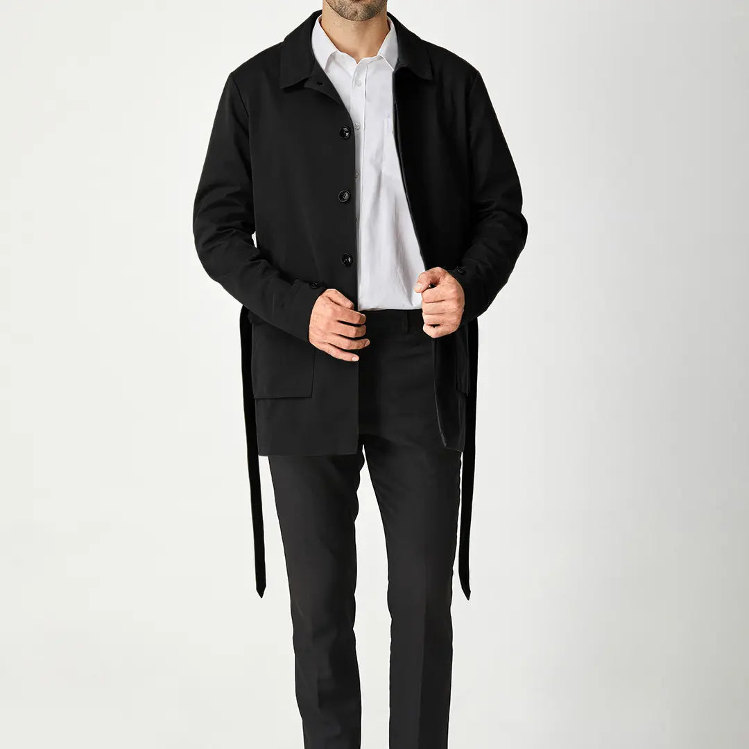 Black men's short trench coat with button front, long sleeves and rear storm flap