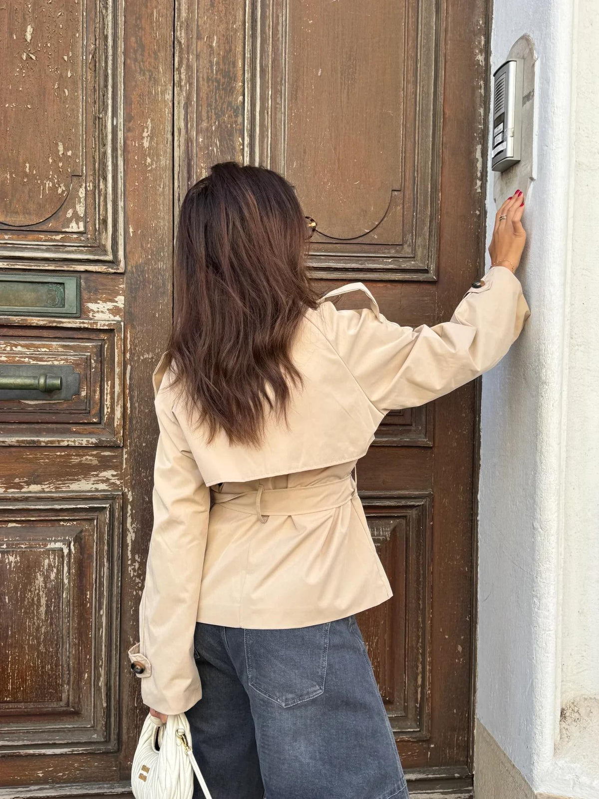Women's belted button-front trench jacket with high collar and long sleeves