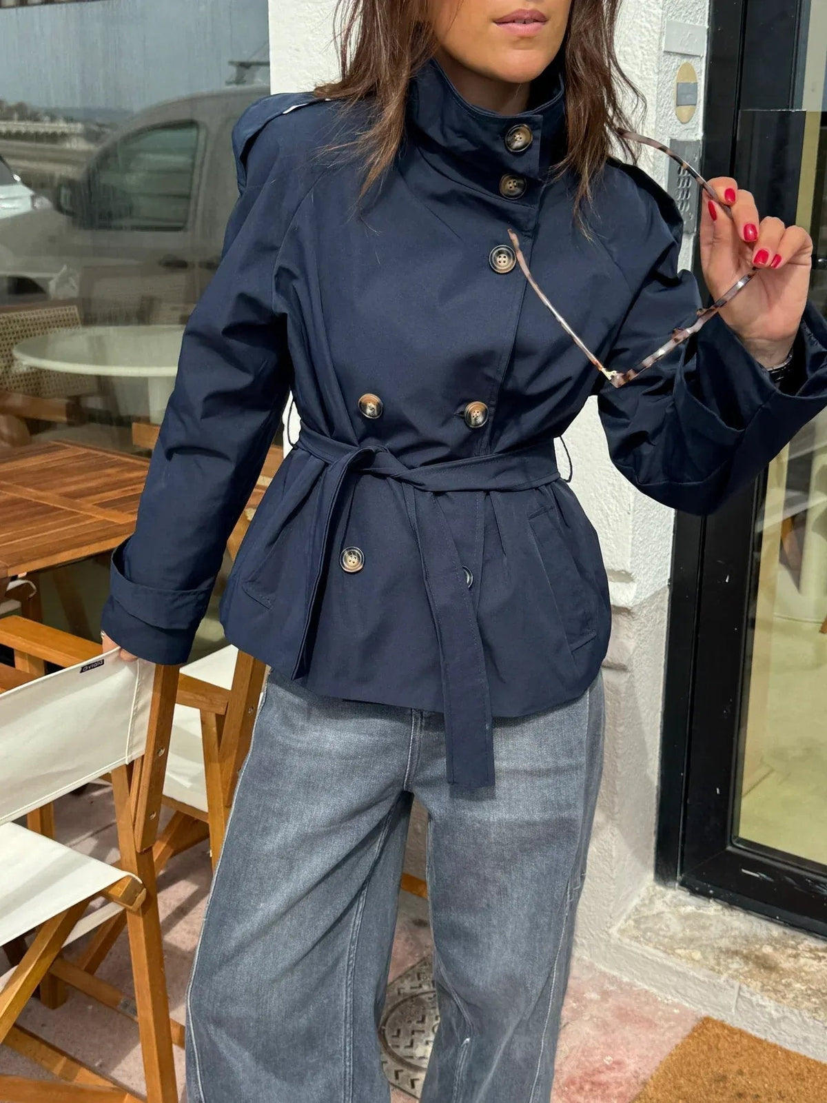 Women's belted button-front trench jacket with high collar and long sleeves