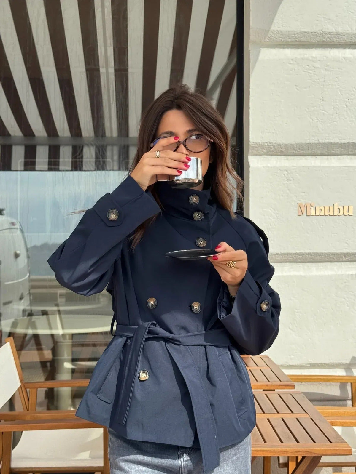 Women's belted button-front trench jacket with high collar and long sleeves