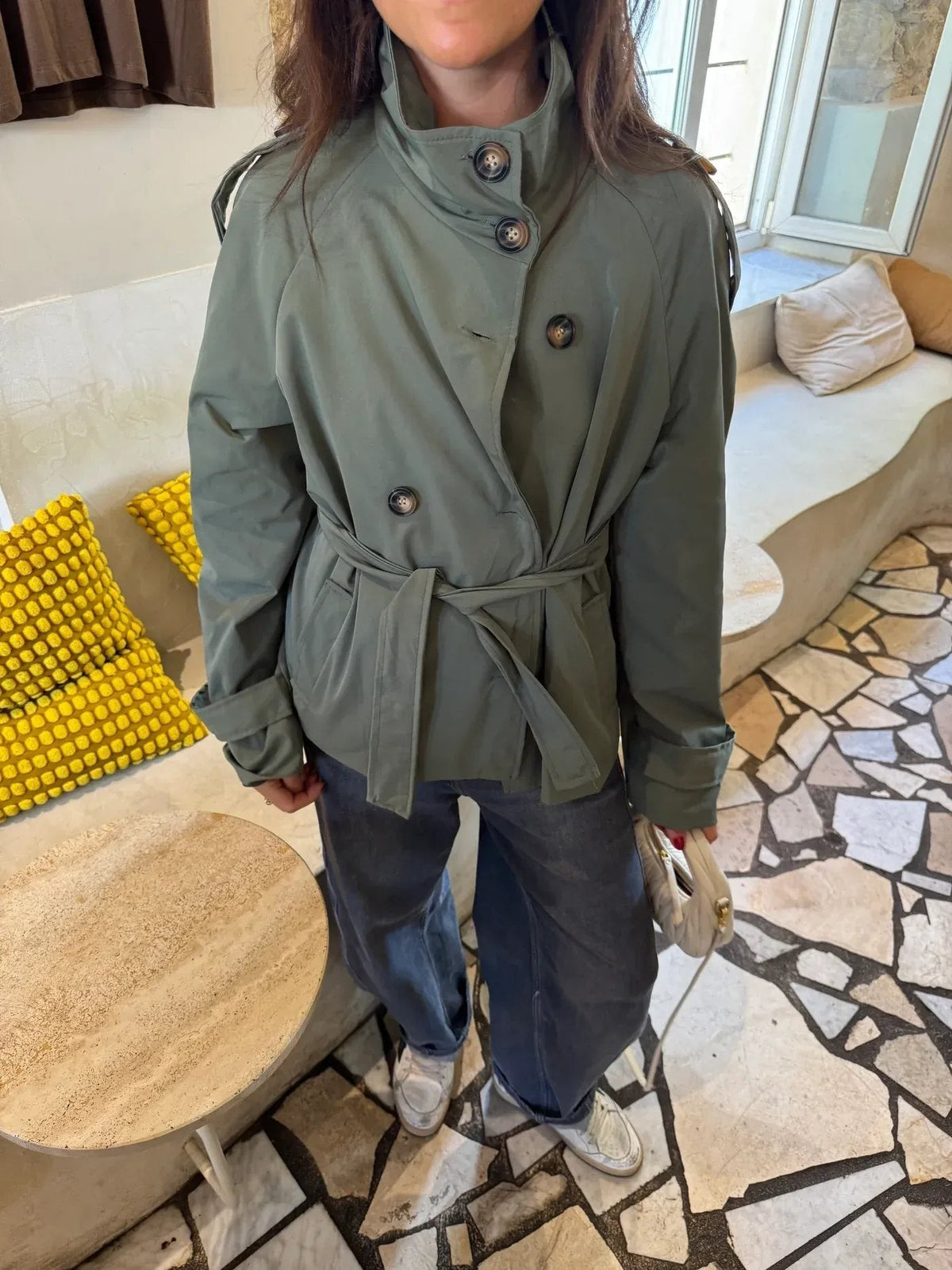 Women's belted button-front trench jacket with high collar and long sleeves