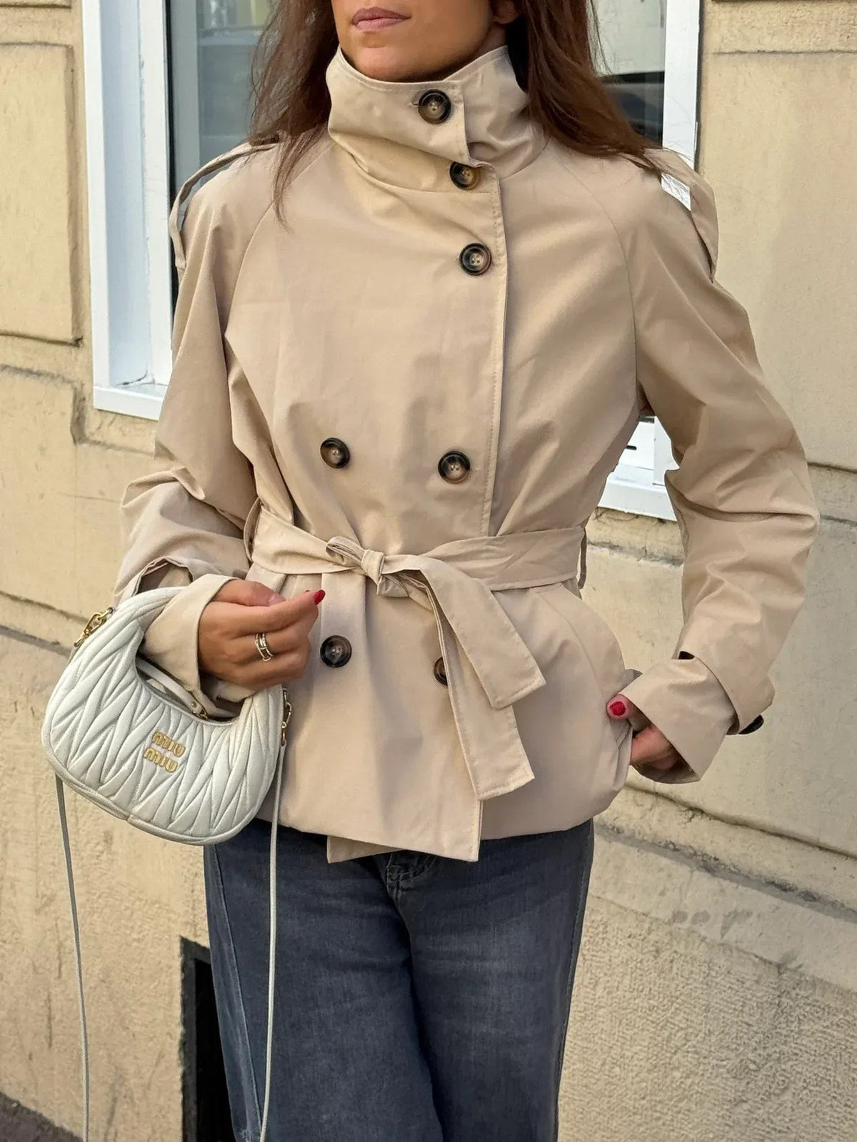 Women's belted button-front trench jacket with high collar and long sleeves