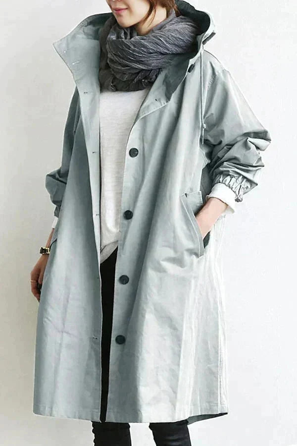 Women's longline hooded raincoat with button front and elasticated cuffs