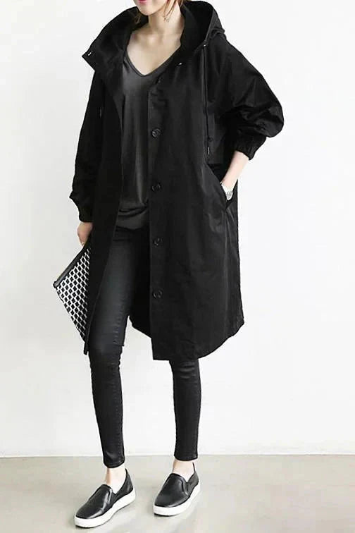 Women's longline hooded raincoat with button front and elasticated cuffs