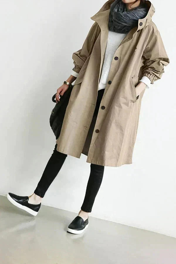 Women's longline hooded raincoat with button front and elasticated cuffs