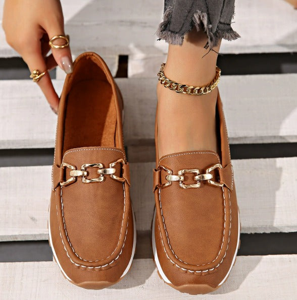 Women's flat loafers with metallic buckle trim and textured lug soles