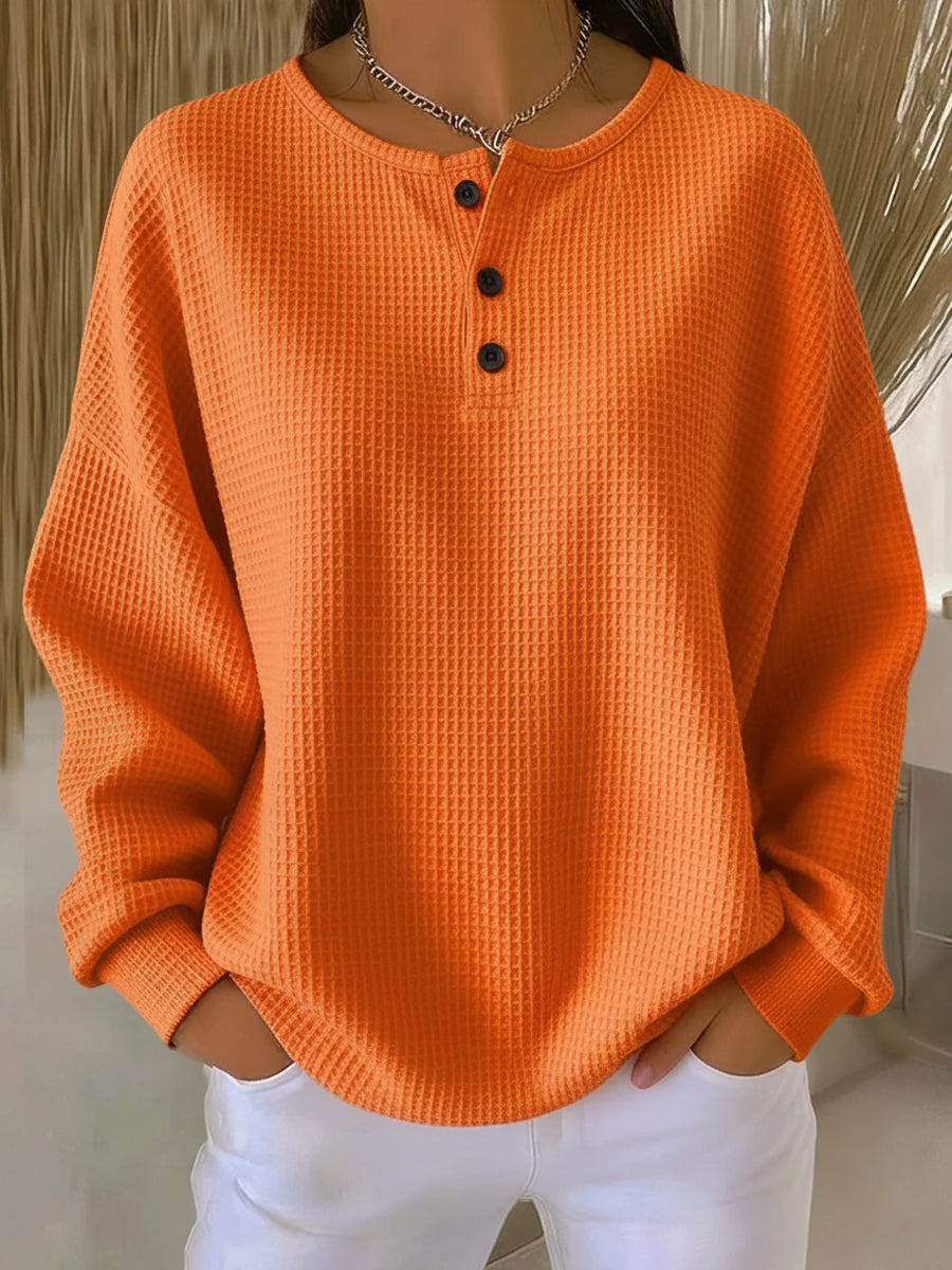 Women's textured waffle Henley top with round neck, long sleeves and button placket