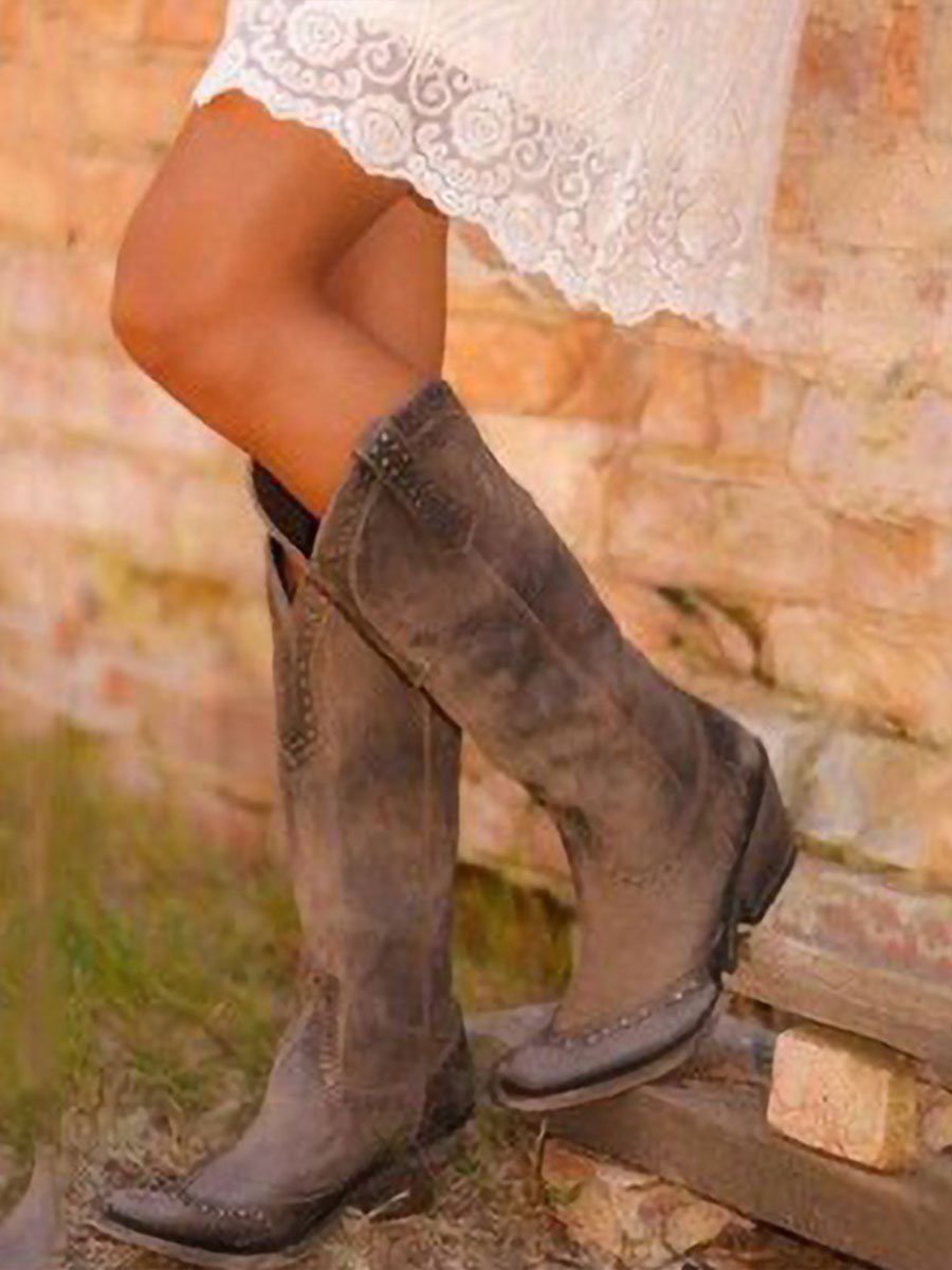 Women's studded cowboy boots with pointed toes, pull tabs and low heels