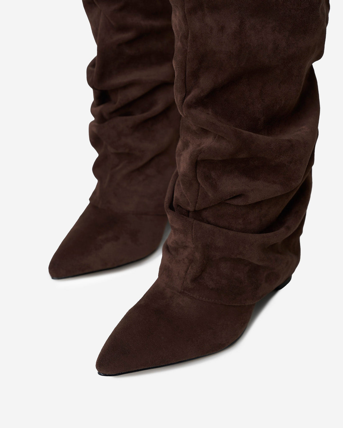 Women's brown slouchy knee-high boots with pointed toes, buckle trim and low heels