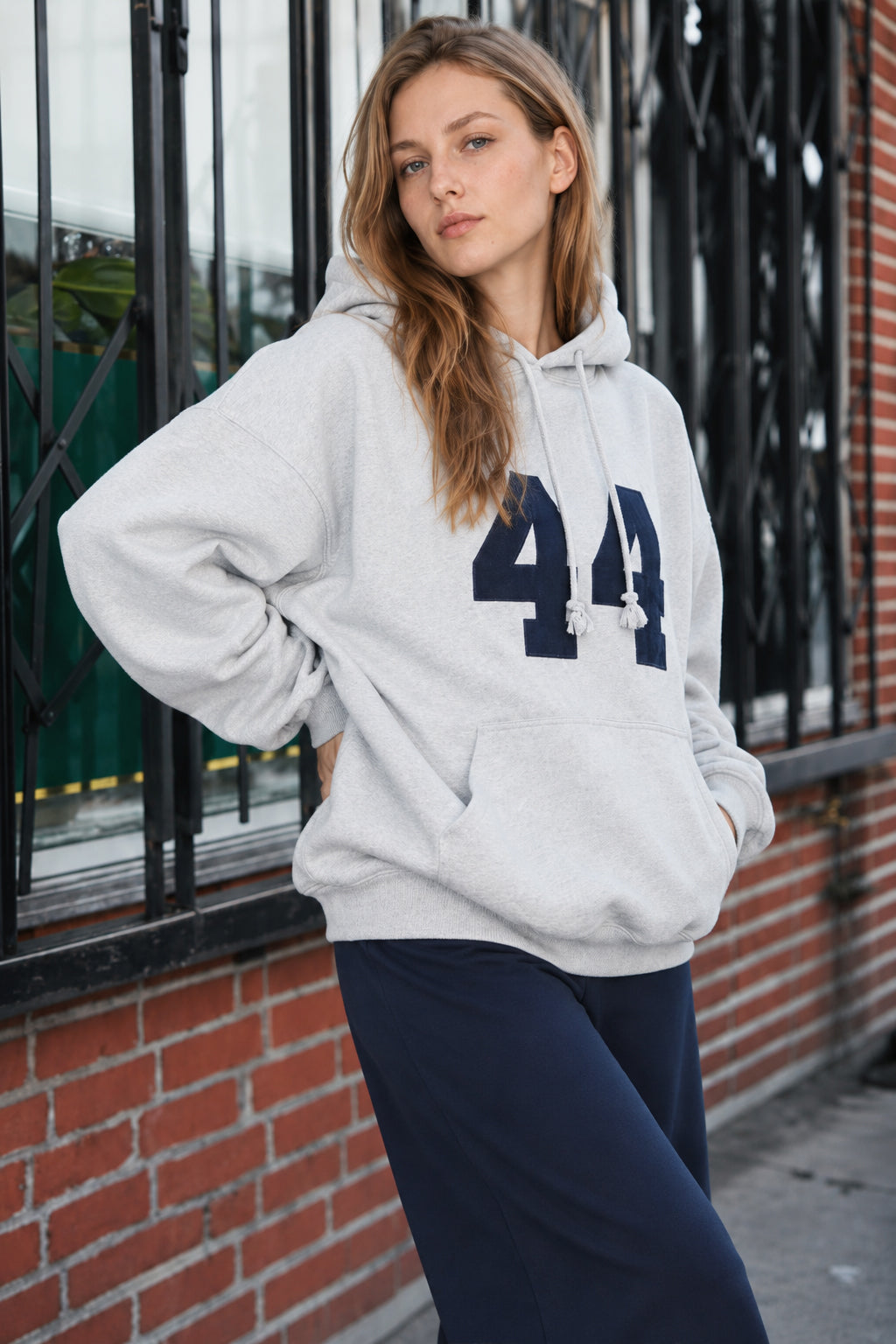 Women's oversized hoodie with hood, front kangaroo pocket and bold number graphic