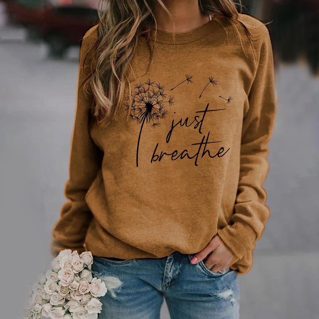 Women's long sleeve crew neck sweatshirt with dandelion and Just Breathe graphic