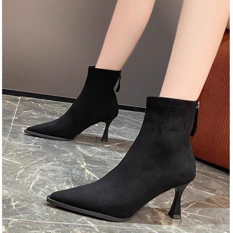 Women's pointed-toe ankle boots with slim high heels and ankle tie details