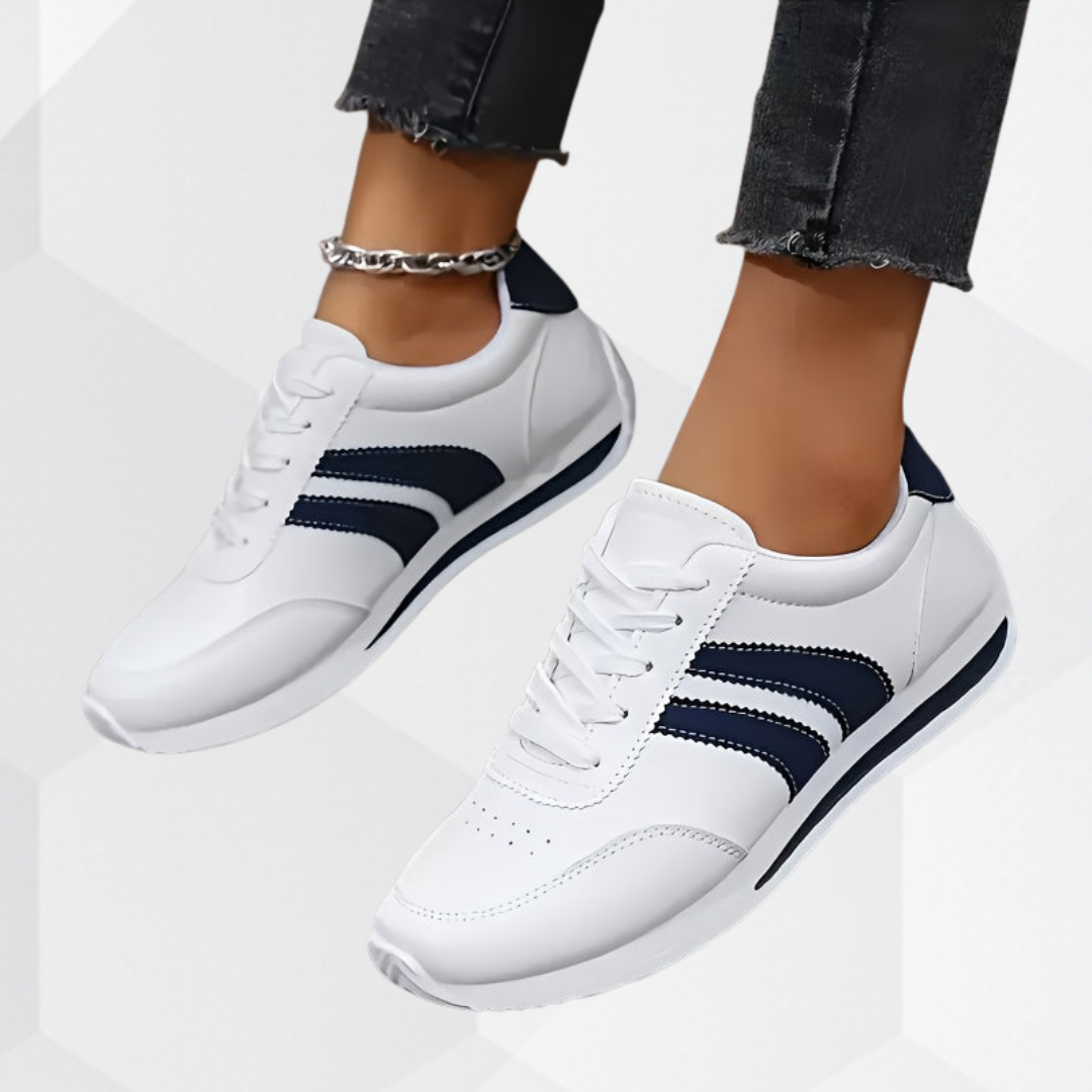 Women's white lace-up sneakers with navy side stripes and flat soles
