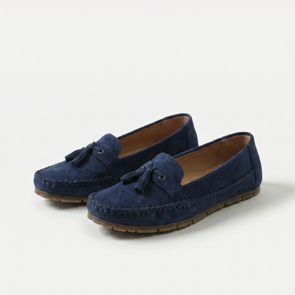 Women's slip-on tassel loafers with rounded moc toes and flat textured soles