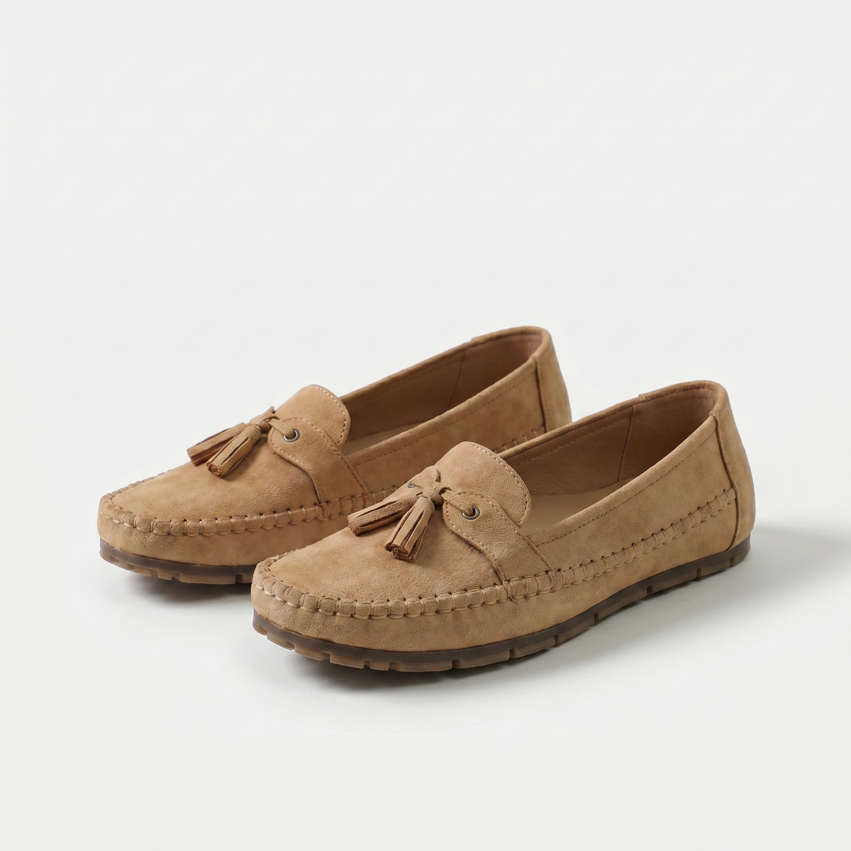 Women's slip-on tassel loafers with rounded moc toes and flat textured soles