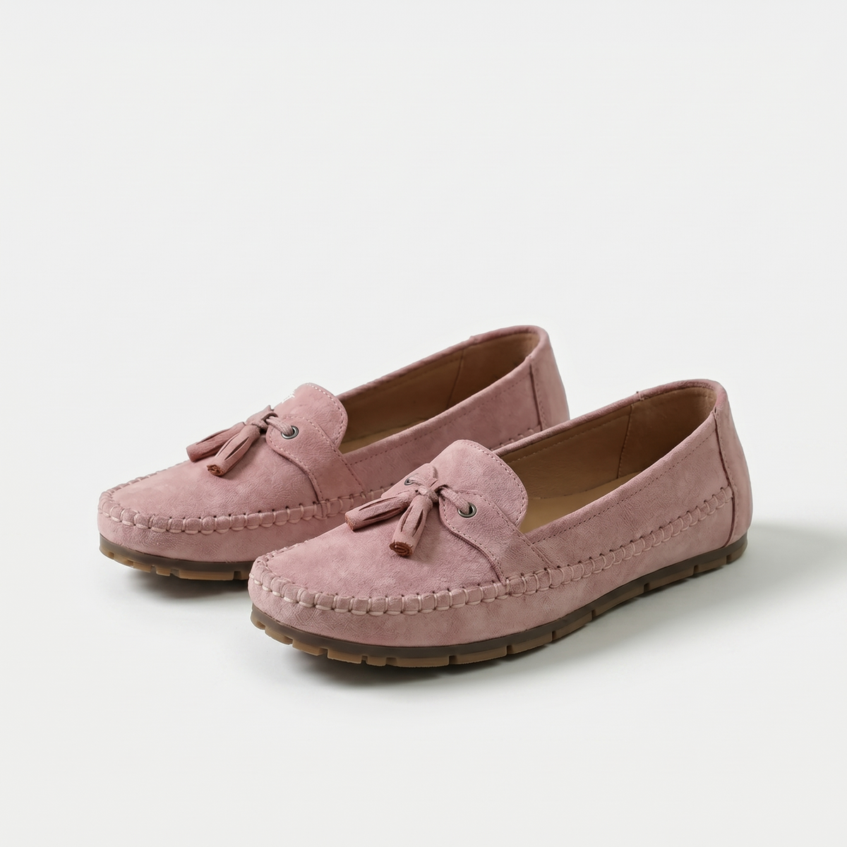 Women's slip-on tassel loafers with rounded moc toes and flat textured soles