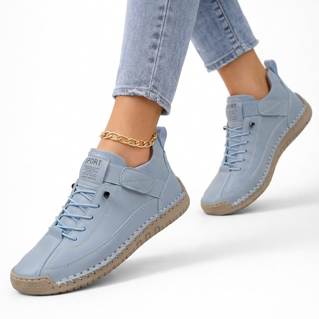 Women's lace-up ankle sneakers with rounded toes, strap detail and flat textured soles