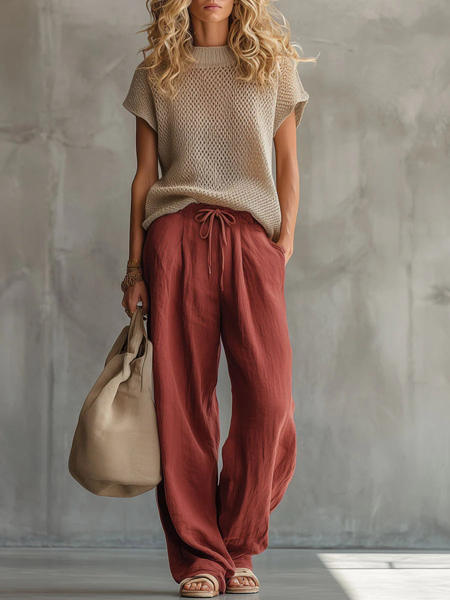 Woman wearing a knitted short-sleeve top with wide-leg drawstring trousers