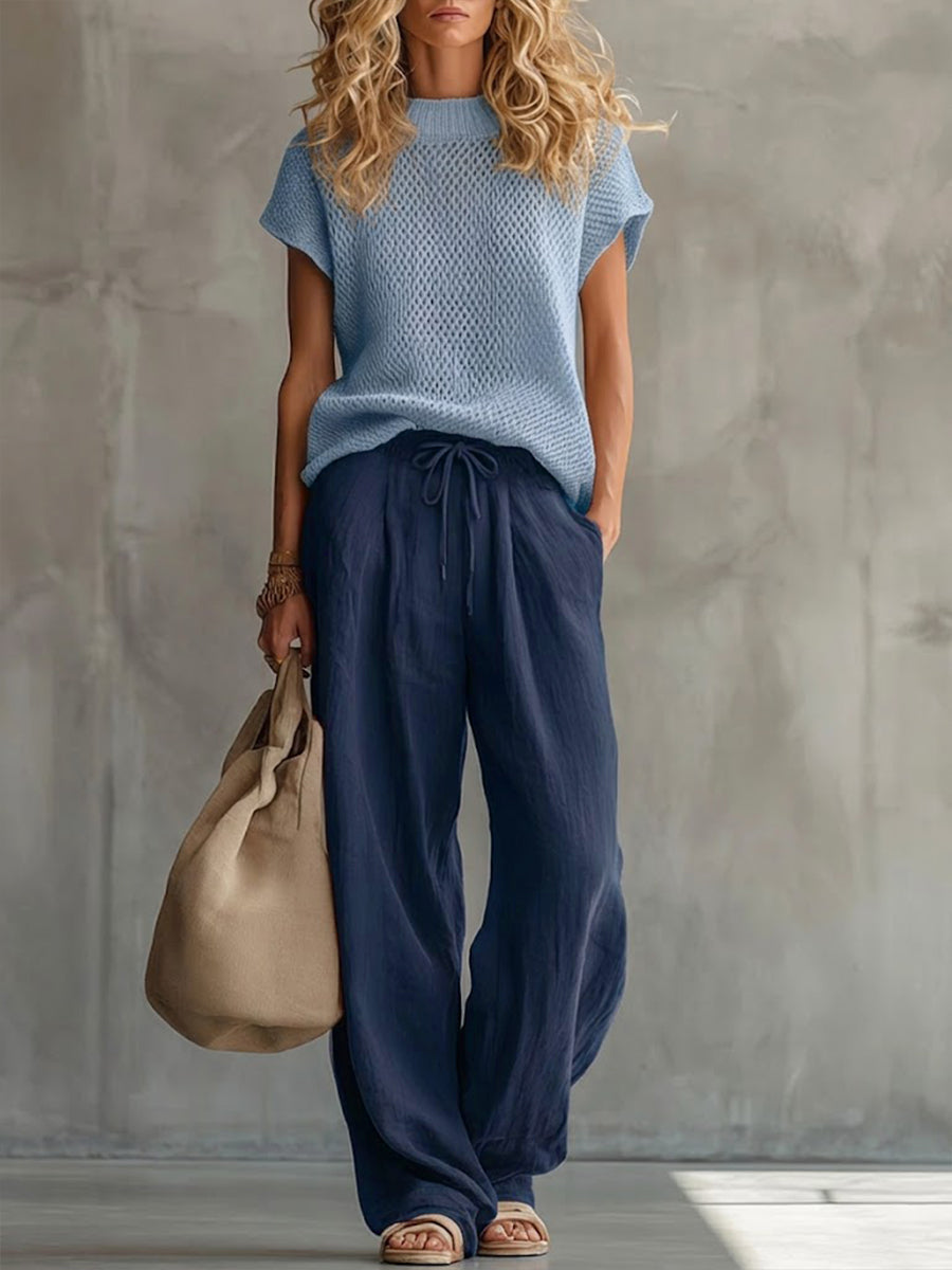 Woman wearing a knitted short-sleeve top with wide-leg drawstring trousers