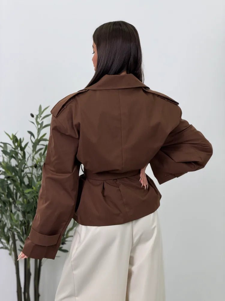 Women's brown cropped trench coat with lapels, tie belt and long sleeves