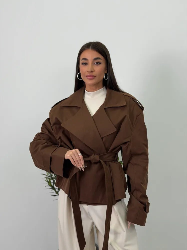 Women's brown cropped trench coat with lapels, tie belt and long sleeves