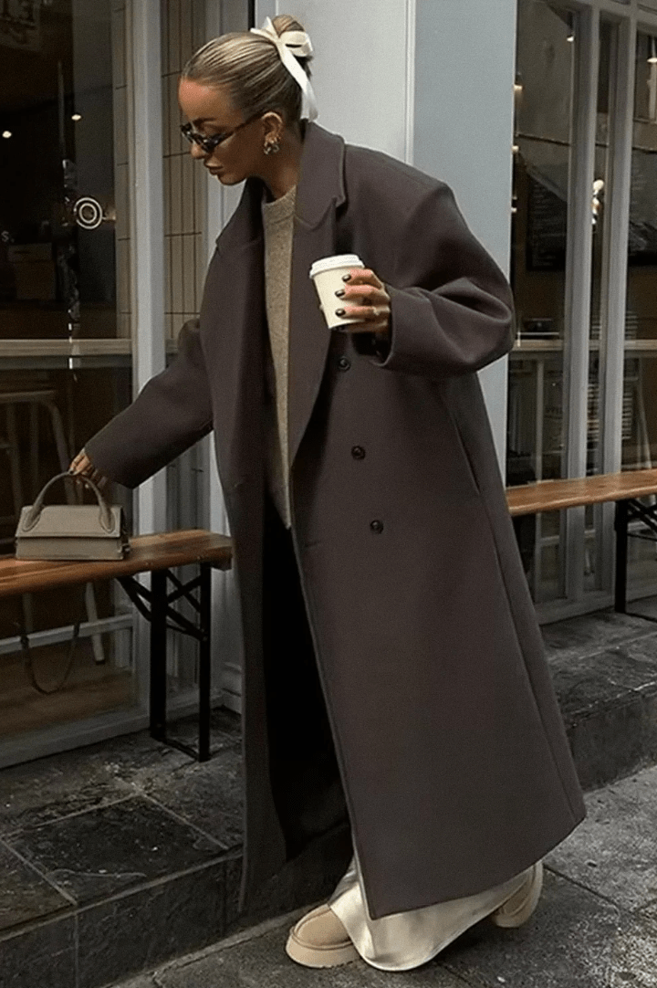 Women's long brown double-breasted coat with notched lapels and long sleeves