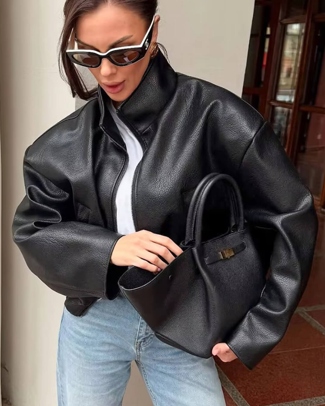 Women's black zip-up jacket with high collar and long sleeves