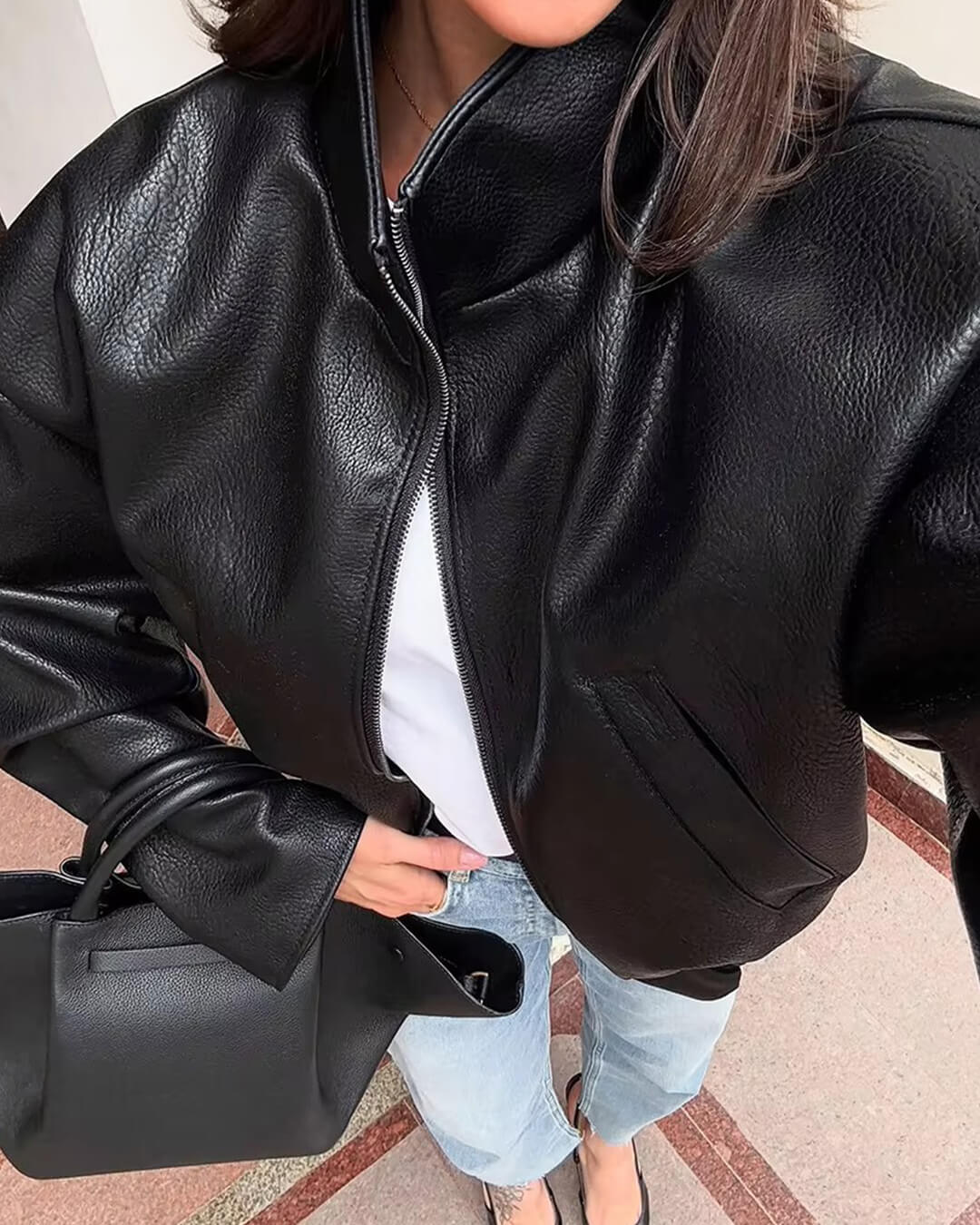 Women's black zip-up jacket with high collar and long sleeves