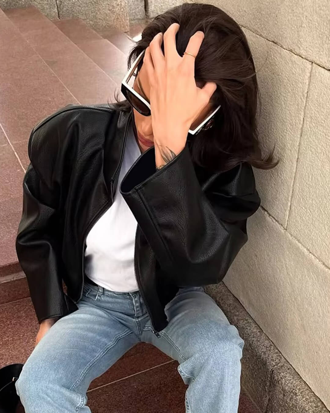 Women's black zip-up jacket with high collar and long sleeves