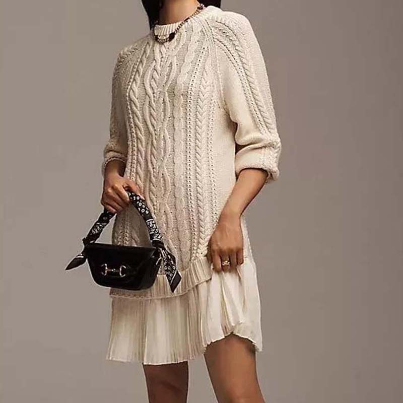 Women's cable knit mini dress with crew neck, long sleeves and pleated skirt panel