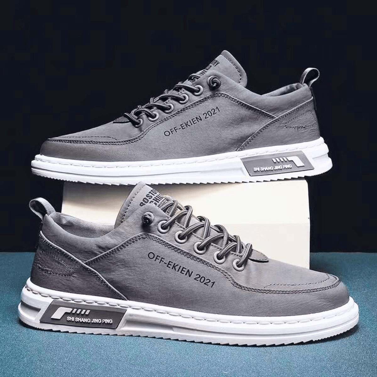 Men's low-top lace-up sneakers with stitched panels, round toes and contrasting white soles