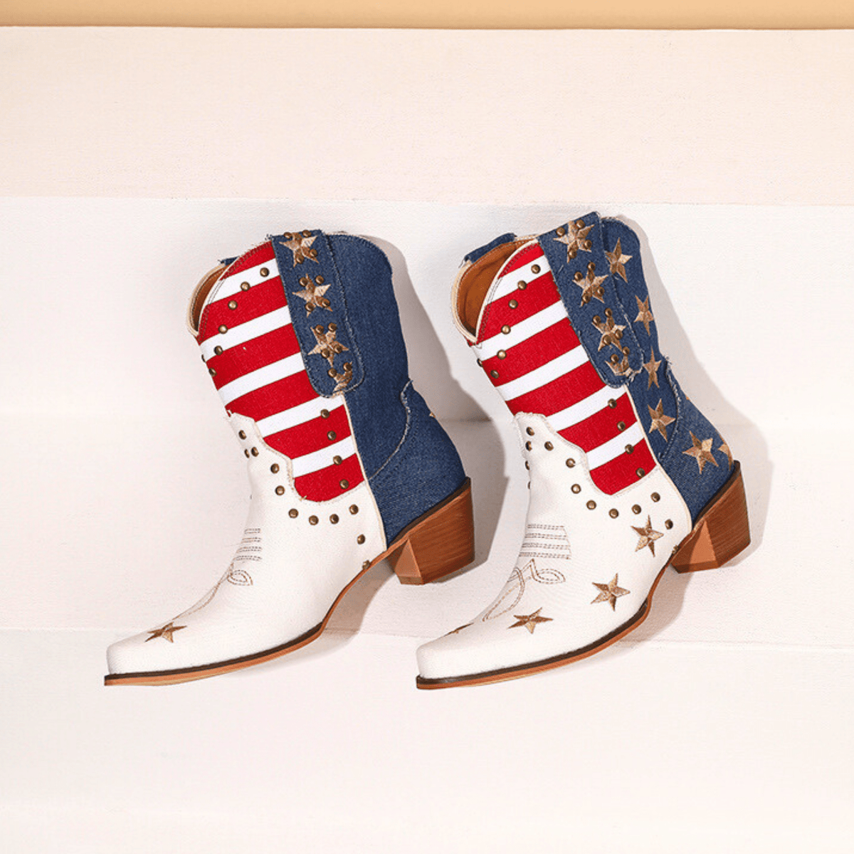 Women's ivory-white cowboy boots with red stripes, blue star panels and pointed toes