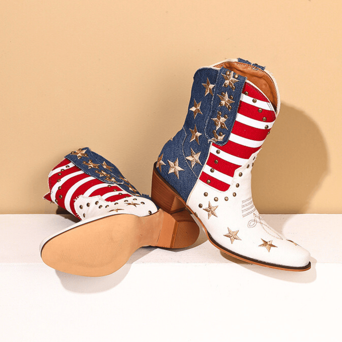 Women's ivory-white cowboy boots with red stripes, blue star panels and pointed toes