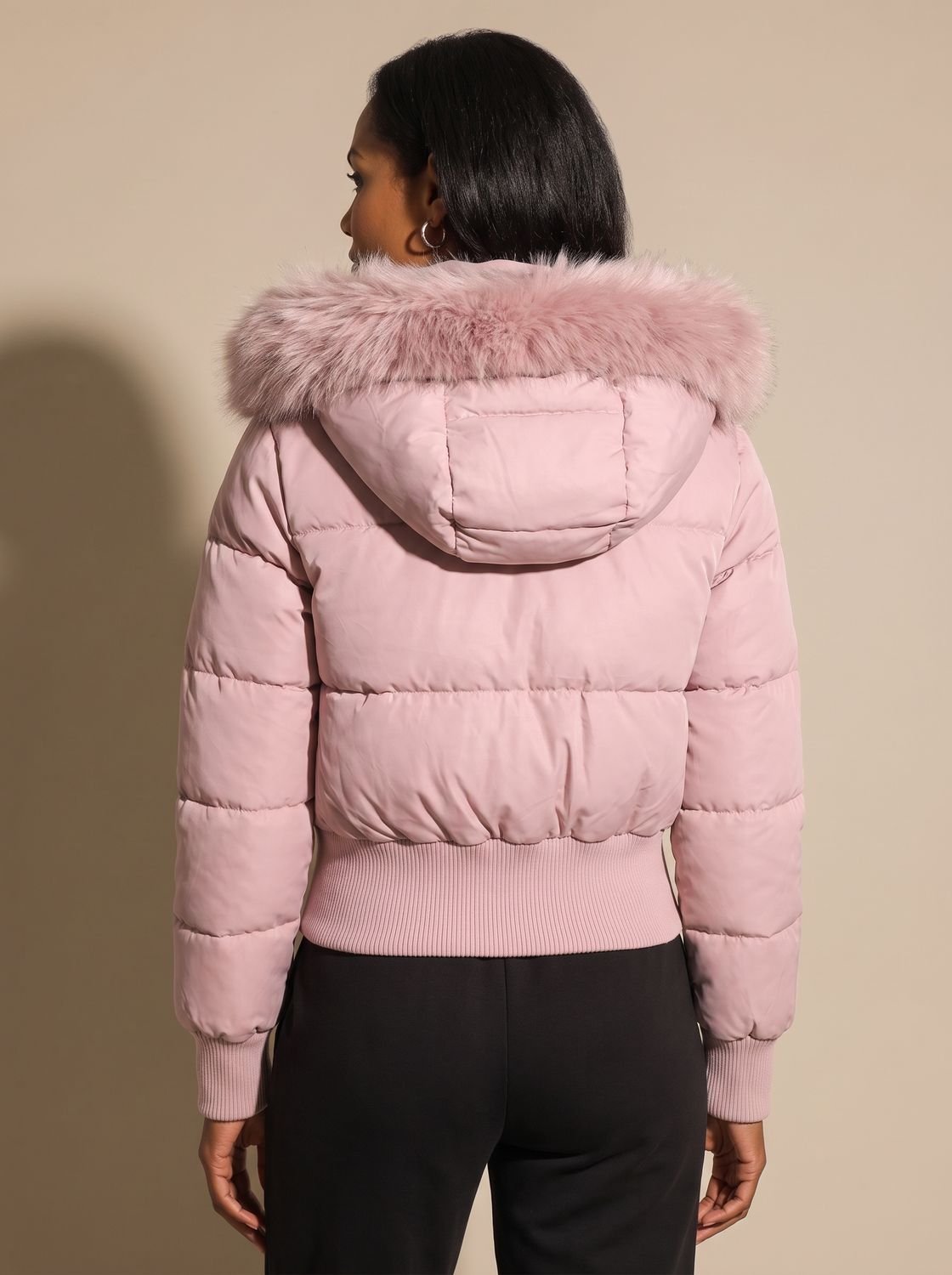 Women's hooded quilted puffer jacket with long sleeves and textured hood trim