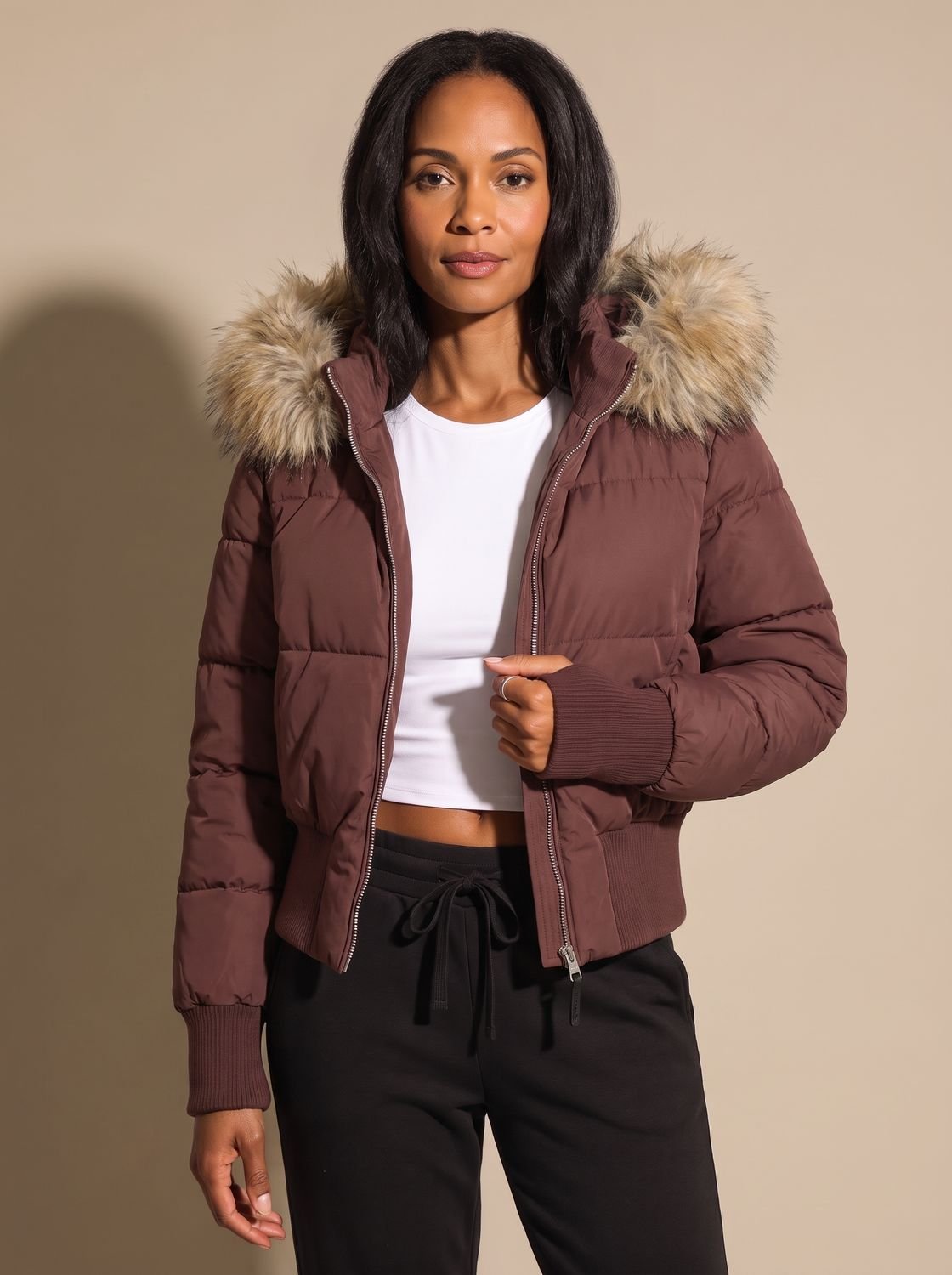 Women's hooded quilted puffer jacket with long sleeves and textured hood trim