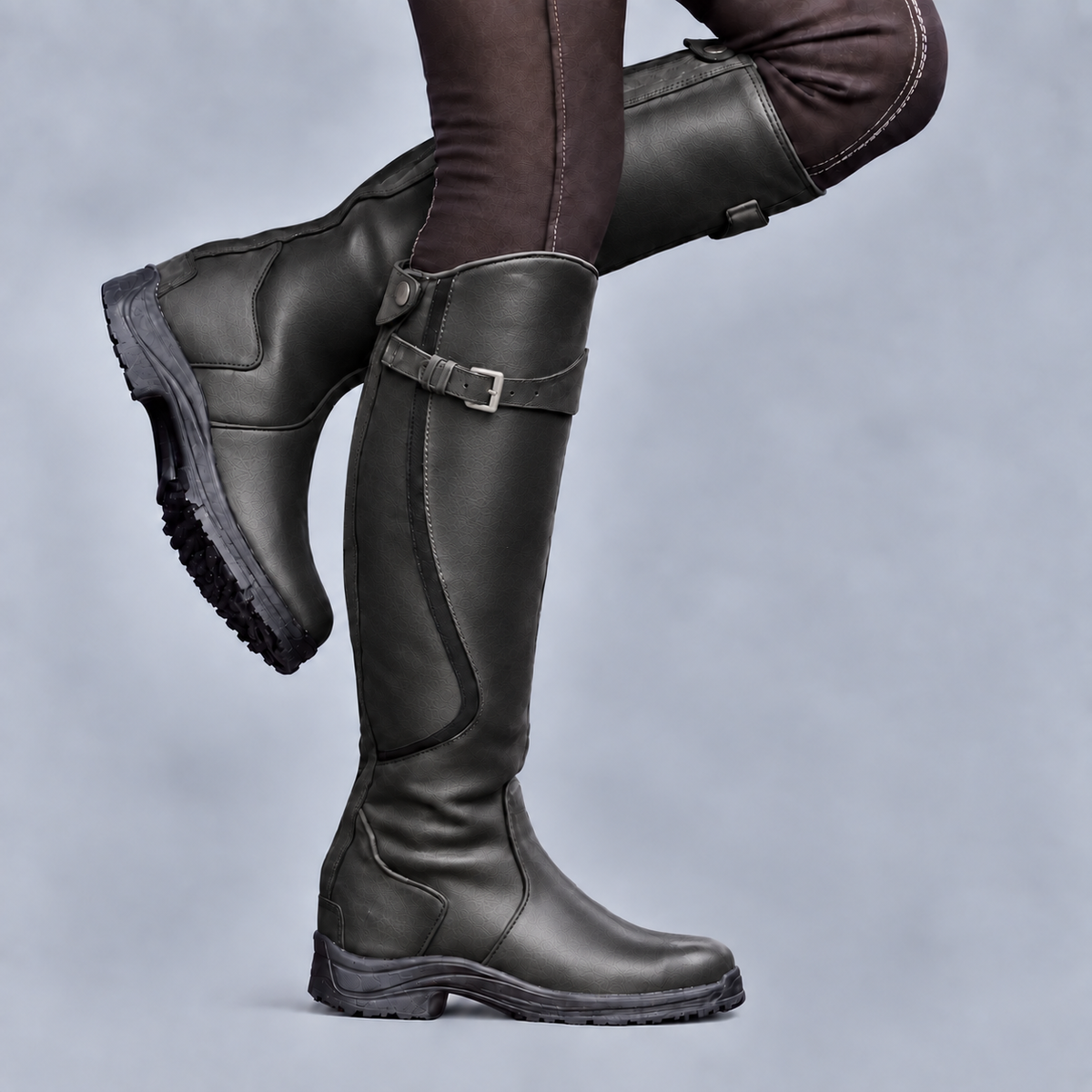 Women's tall riding boots with buckle straps and rugged tread soles