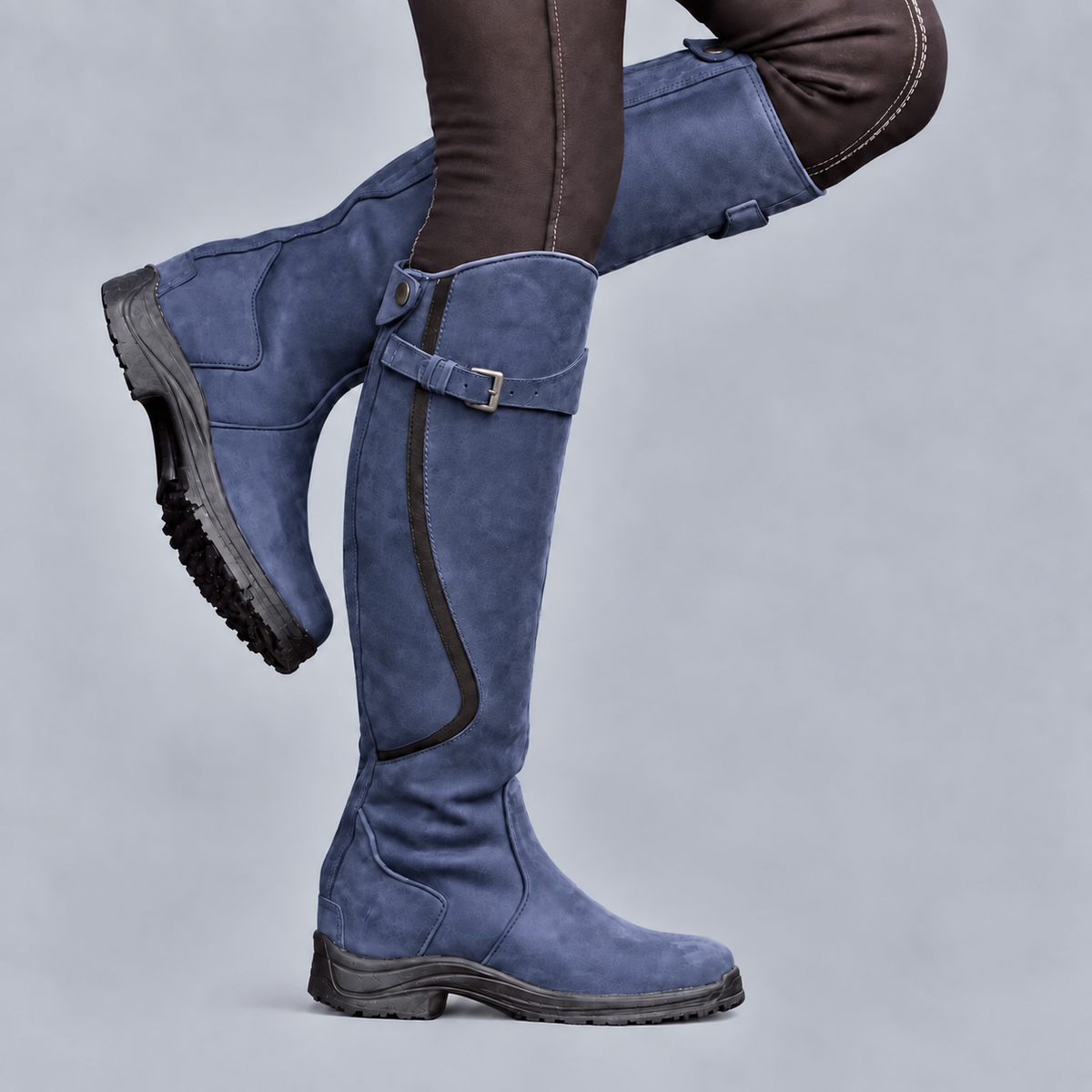 Women's tall riding boots with buckle straps and rugged tread soles