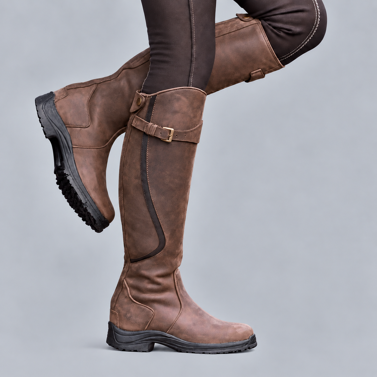 Women's tall riding boots with buckle straps and rugged tread soles