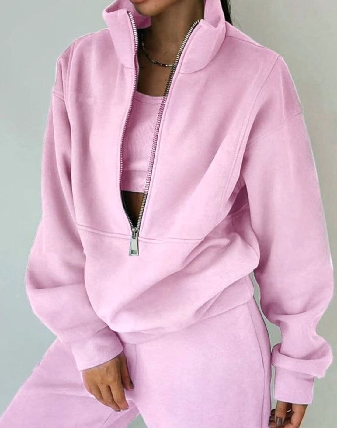 Women's cropped sweatshirt and trousers tracksuit set with raised neck and front zip