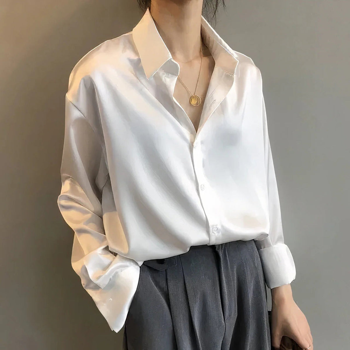 Women's plain long-sleeve button-down blouse with pointed collar and relaxed fit